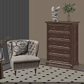 Beige Single Sofa With Patterned Cushion Near Small Side Table Wooden Dresser on Checkered Rug