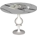 Round White Marble Dining Table With Natural Veins Magazines Teacup On White Pedestal Base