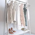 White Clothes Rack with Hanging Polka Dot Pink Green White Dresses Blouses and Shoes