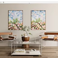Modern Living Room With Floral Paintings Two Chairs Glass Coffee Table Vase And Books
