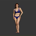 Woman Standing in Blue Bikini Against Gray Studio Background