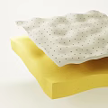 Two Stacked Sponges Top White With Black Dots Bottom Yellow And Wavy Edges