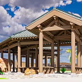 Traditional Open Wooden Pavilion Featuring Green Tiled Roof And Stone Surroundings