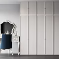 Modern Bedroom Interior With White Paneled Wardrobe Dressing Table Mirror And Blue Chair