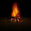 Garden Ornament Featuring Burning Bonfire with Flaming Logs and Bright Flames at Night