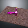Rustic Wooden Table Displaying Pink Spinning Tops With Gold Accents