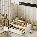 Kitchen Utensils in Open White Drawer With Spice Jars Wooden Cutting Boards and Striped Tiles
