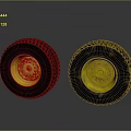 Two Black Tires Featuring Yellow Rims and Muddy Worn Tread Surfaces