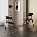 Two Modern Black Dining Chairs With Sleek Backrest Design In Interior