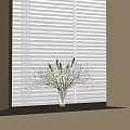 Clear Glass Vase With White And Purple Flowers On Windowsill Against Blinds Background