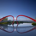 Red Arch Bridge Modern Design With White Cables Reflection On Calm Water Surface And Trees 3d model