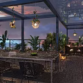 Outdoor Restaurant Terrace with Umbrellas Tables Chairs Green Plants Stone Path Lighting and Sunset Sky