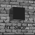 Black Square Wall Lamp Mounted On Brick Wall Illuminating Wall Surface And MY SHOP Letters