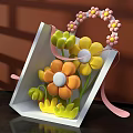 Decorative Floral Display in White Triangular Box with Colorful Flowers Pink Ribbons and Flower Handle
