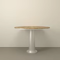 Round Dining Table with Wooden Top and Silver Metal Pedestal against Light Wall Gray Floor