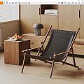 Wooden Frame Black Cushion Lounge Chair With Side Table Fruit Basket In Natural Light