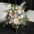 Colorful Mixed Flowers Arrangement In Black Vase With Gold Base And Green Leaves Ferns
