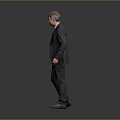 Man In Formal Suit And Tie Standing Confidently Against Gray Background