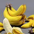 Fresh Ripe Yellow Banana Bunches With a Peeled One on Gray Background