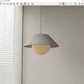 Modern Pendant Light Featuring Fabric Shade And Round Globe In Light Colored Room