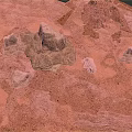 Red Desert Natural Landscape With Undulating Sandy Ground And Rock Formations