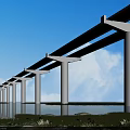 Elevated Bridge with White Piers Spanning Water Under Blue Sky White Clouds and Green Vegetation
