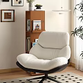 Plush White Lounge Chair With Wooden Shelf Wall Art And Green Plant