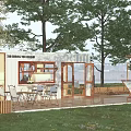 Container Building Coffee Shop With Outdoor Seating Lawn Trees And Pergola