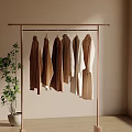 Minimalist Clothes Rack With Neutral Tones Coats And Green Plant Against Light Wall