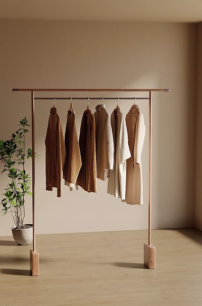 Minimalist Clothes Rack With Neutral Tones Coats And Green Plant Against Light Wall 3d model