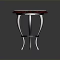 Elegant Round Top Stool With White Marble And Dark Carved Legs On Square Tiled Floor