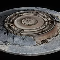 Urban Road Facility Featuring Circular Aged Metal Manhole Cover On Pavement