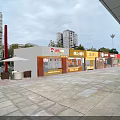 Vibrant Commercial Street With Modern Shops Paved Square Outdoor Seating And High Rise Buildings