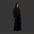 Stylish Woman In Long Dark Coat With Brown And Blue Panels And Pockets Standing