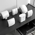 Sleek White Hand Dryers Arranged On Dark Office Table With Modern Design