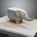 Cute Elephant Shaped Stool With Grey Fabric Upholstery And Wooden Legs
