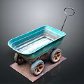 Blue Vintage Wheelbarrow with Four Rustic Wheels on Brown Mat Against Dark Background