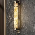 Modern Wall Lamp With Brass Frame Glass Shade Mounted On Marble Wall Emitting Warm Light