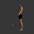 Barefoot Male Swimmer in Blue Cap and Goggles Standing with Outstretched Arms on Gray Background
