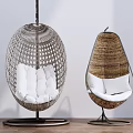 Modern Woven Hanging Chairs With White Cushions And Metal Stands For Indoor Use