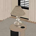 Beige Fabric Lampshade Table Lamp With Transparent Stacked Spherical Base On White Round Table