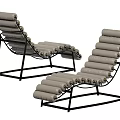 Modern Lounge Chair With Black Metal Frame And Gray Padded Rolls