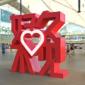Red 3D Chinese Characters Art Installation Featuring White Heart Shape In Indoor Hall