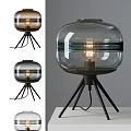 Modern Glass Shade Table Lamp With Black Tripod Base And Warm Lighting Design