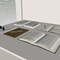 Open Books and Magazines on White Table with Notebook Pen and Sunglasses