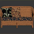 Orange Rattan Two Seater Sofa With Blue Cushions And Leaf Patterned Pillows