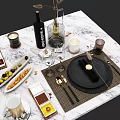 Elegant Dinnerware Set on Marble Tabletop with Black Plates Golden Cutlery Glassware and Accessories