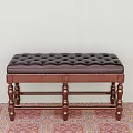 Classic Tufted Leather Sofa Bench With Carved Wooden Legs On Patterned Carpet
