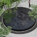 Garden Scene With Circular Black Rockery Stone Surrounded By Green Trees Grass And Paved Ground