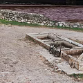 Natural Outdoor Scene With Stone Troughs Bicycle Gravel Ground And Distant Water